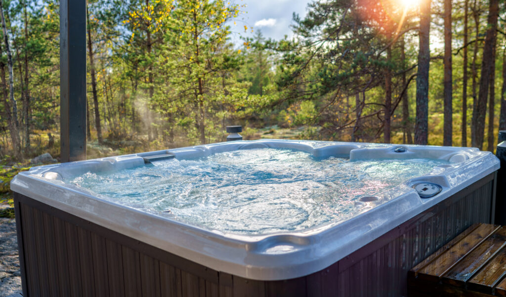 A warm hot tub in a beautiful forest landscape at sunset.