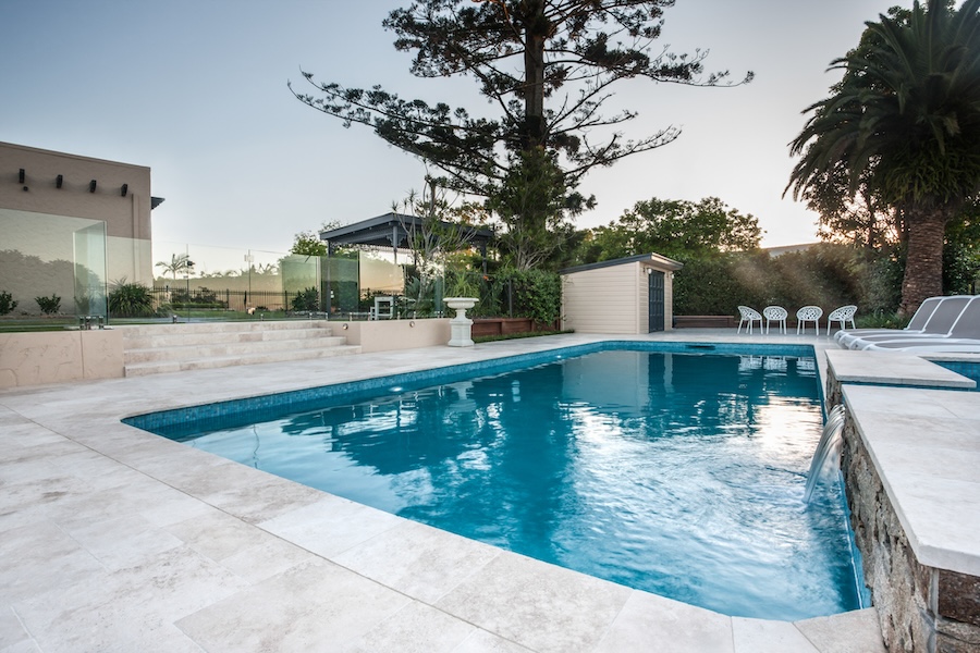 Luxury swimming pool view with blue water poolside with chairs