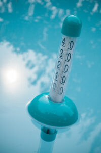 Closeup of pool thermometer in the water