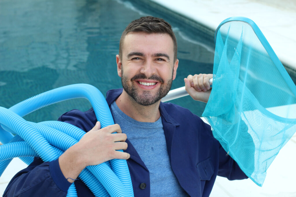 man holding pool cleaning essential equipment ready to work