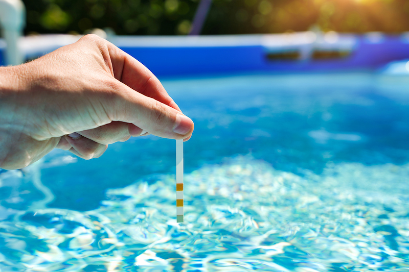 PH test on a swimming pool to maintain balance