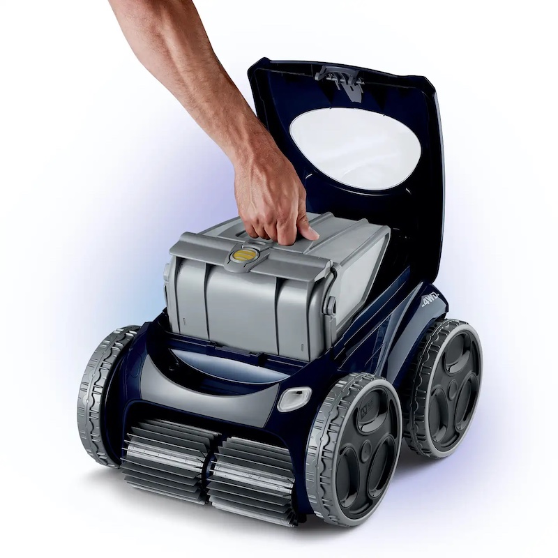 Robot pool vacuum with hand holding it down and white background