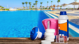 Pool chemicals lined up by pool in the summer