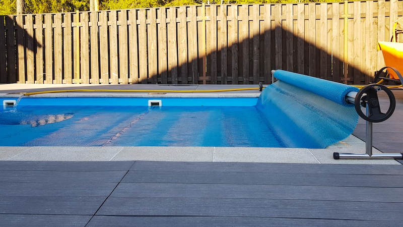 Swimming pool cover for protection against dirt, leaves, heating and cooling water, copy space