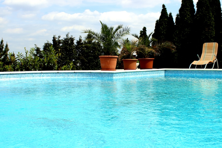 Edge of a luxury pool with potted plants
