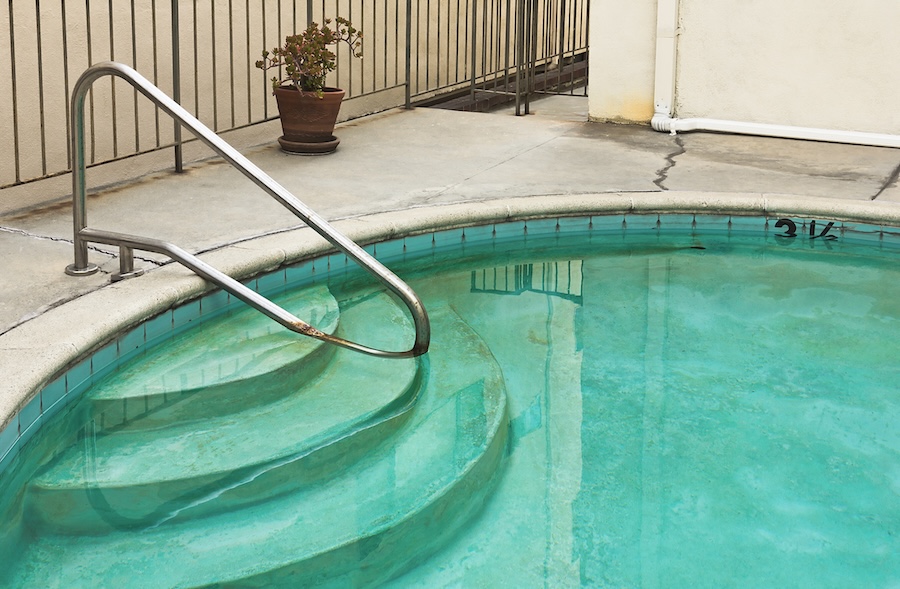 Swimming pool is old and dirty.