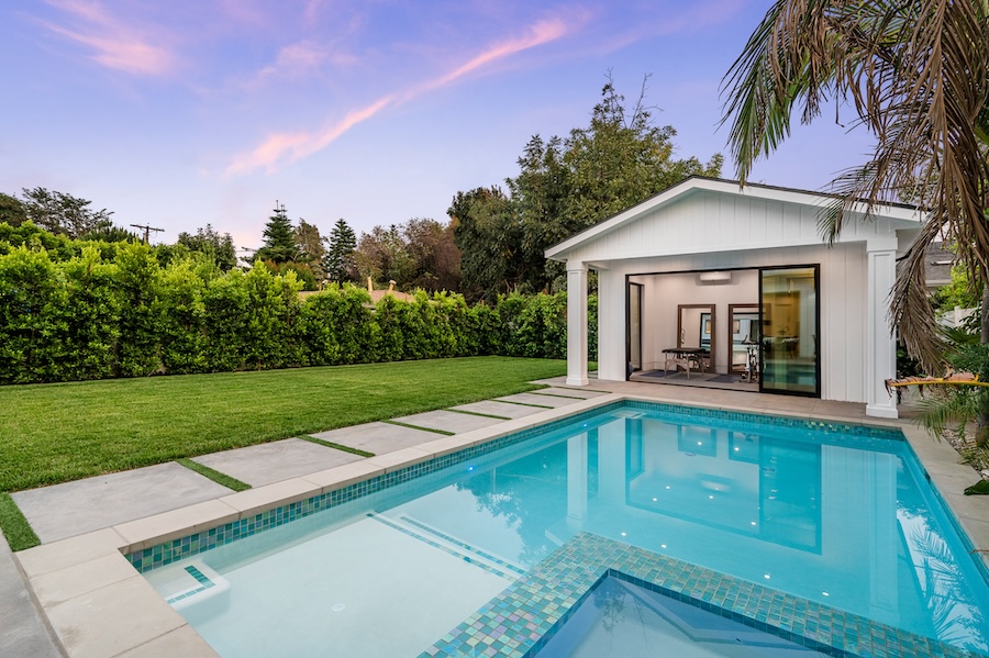 Exterior view of a guest house and a pool