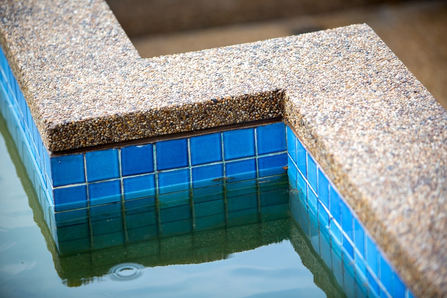 Dirty swimming pool water and pool edge