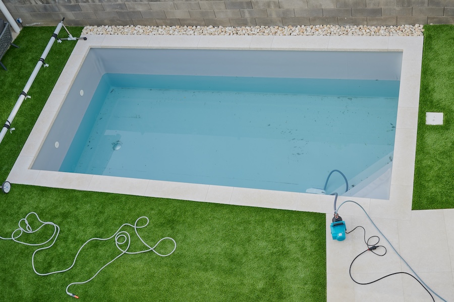 pool cleaning of the dirty water after the winter season
