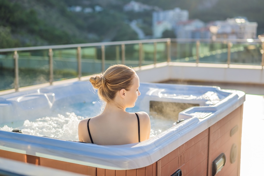 Portrait of young carefree happy smiling woman relaxing at hot tub