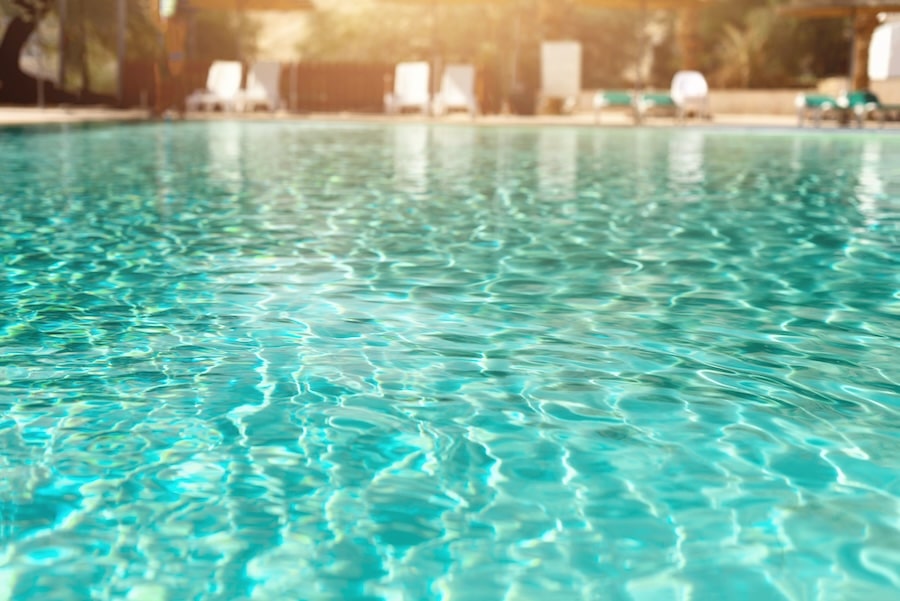 summer-travel-vacation-and-holiday-concept-lounge-chairs-near-swimming-pool-against-judean-desert-turquoise-pool-with-clean-water-sun-beds-greens-of-bamboo-palms-in-tourist-resort-2