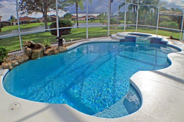 A swimming pool and spa with a lake view.