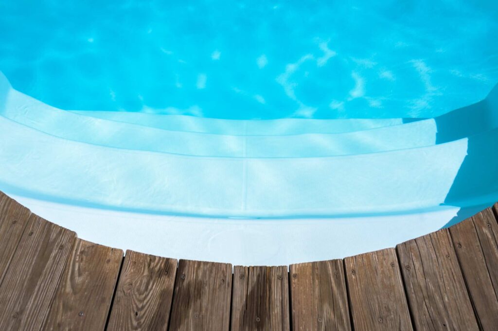View of swimming pool stairs access at the edge of the pool.