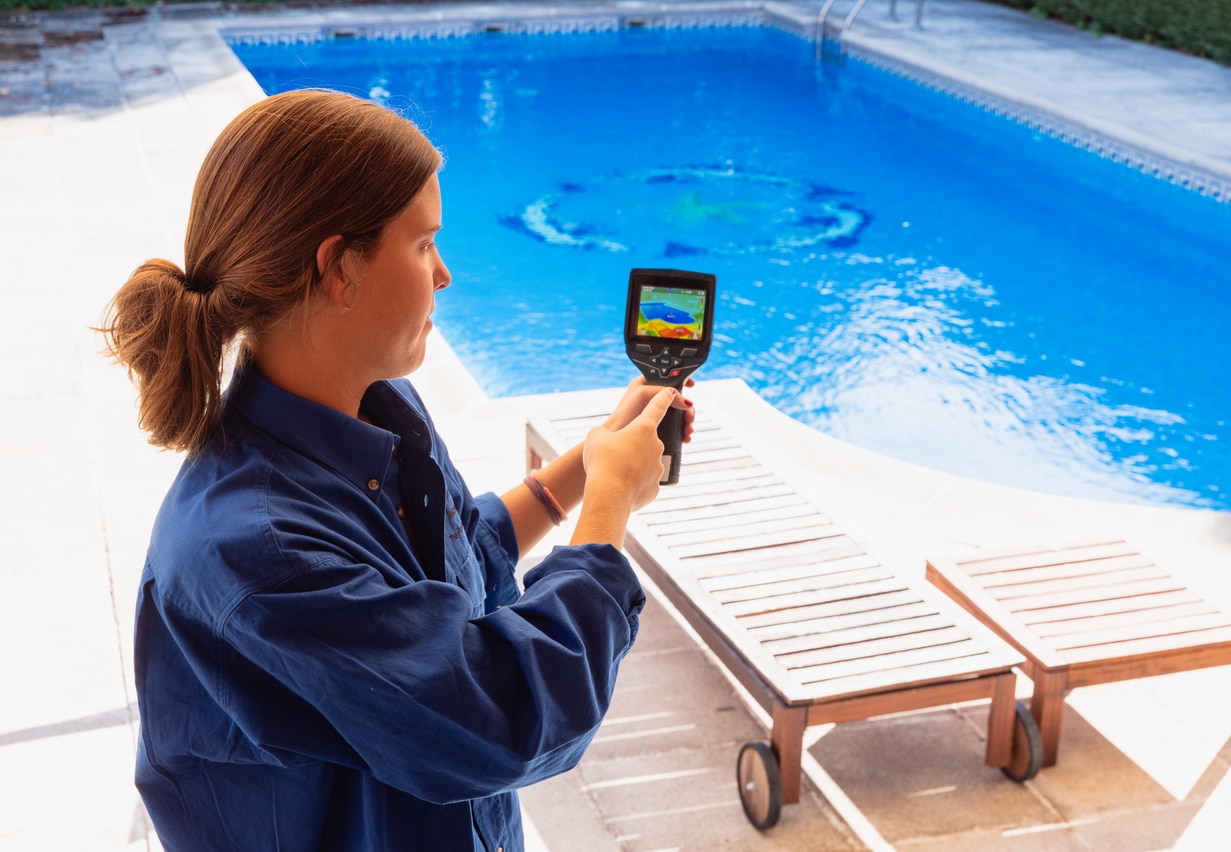 Woman performing inspection on a swimming pool surface