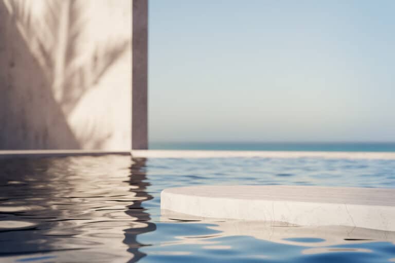 Swimming pool water with sea and sunset view.